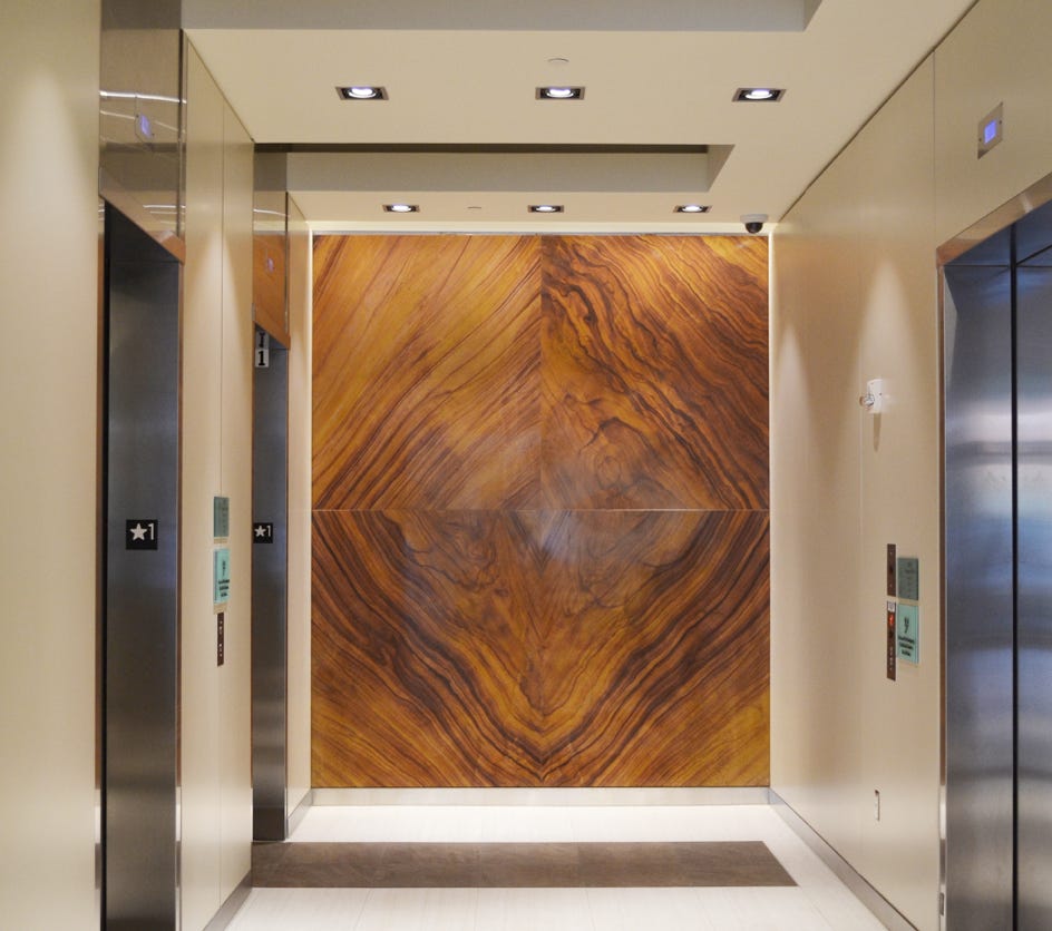 Elevator entry area Stonewall artistic piece square with the shape of a diamond in the stone